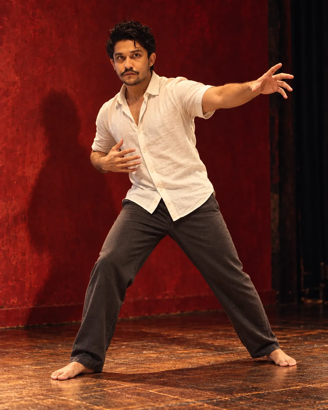 I hold an expressive full-body theatre pose